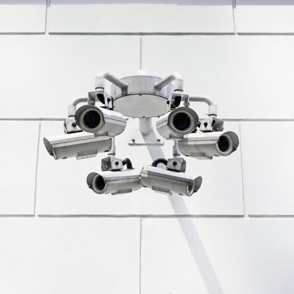 Low Angle View Of Security Cameras On Wall